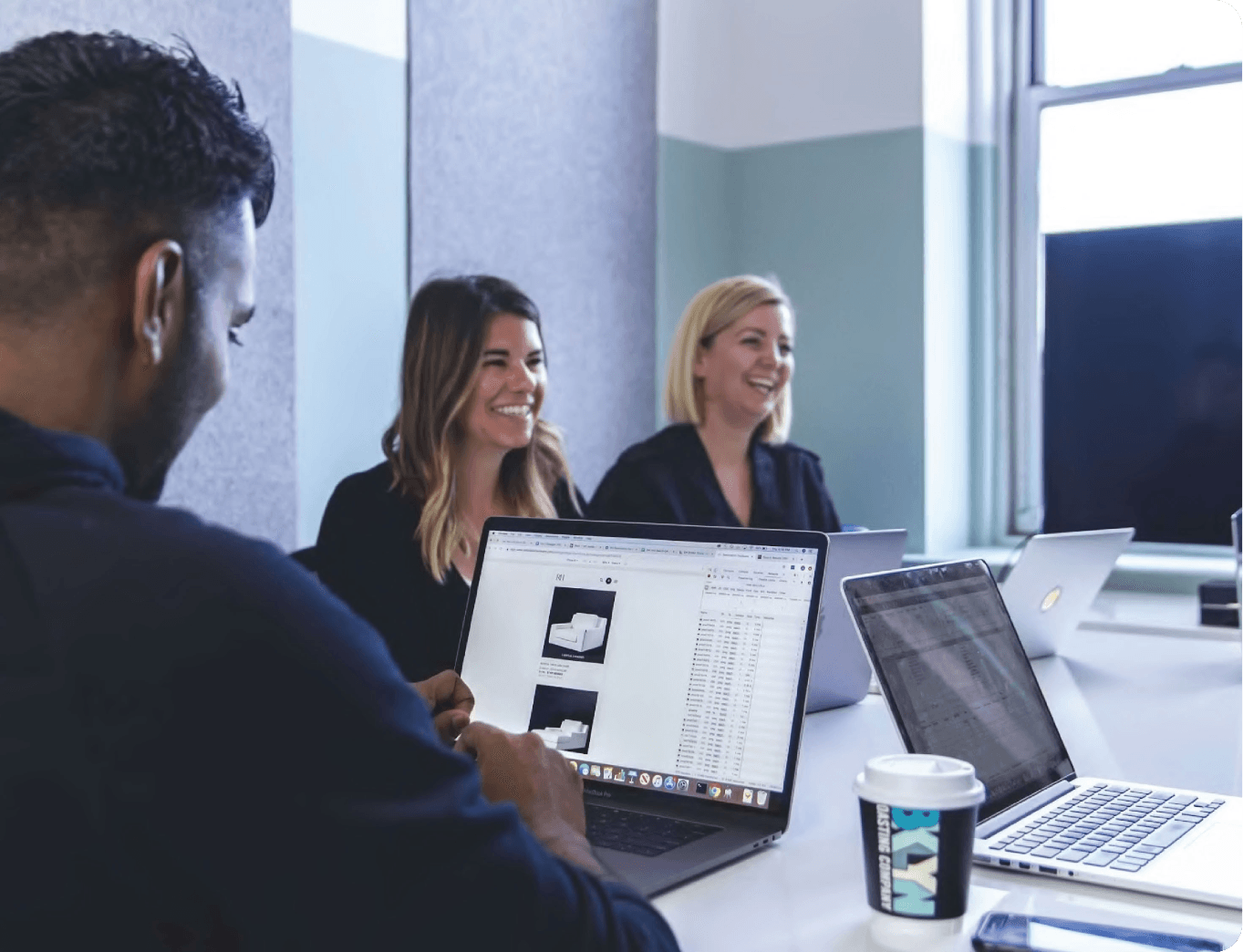 HappyFunCorp team collaborating in a modern office setting