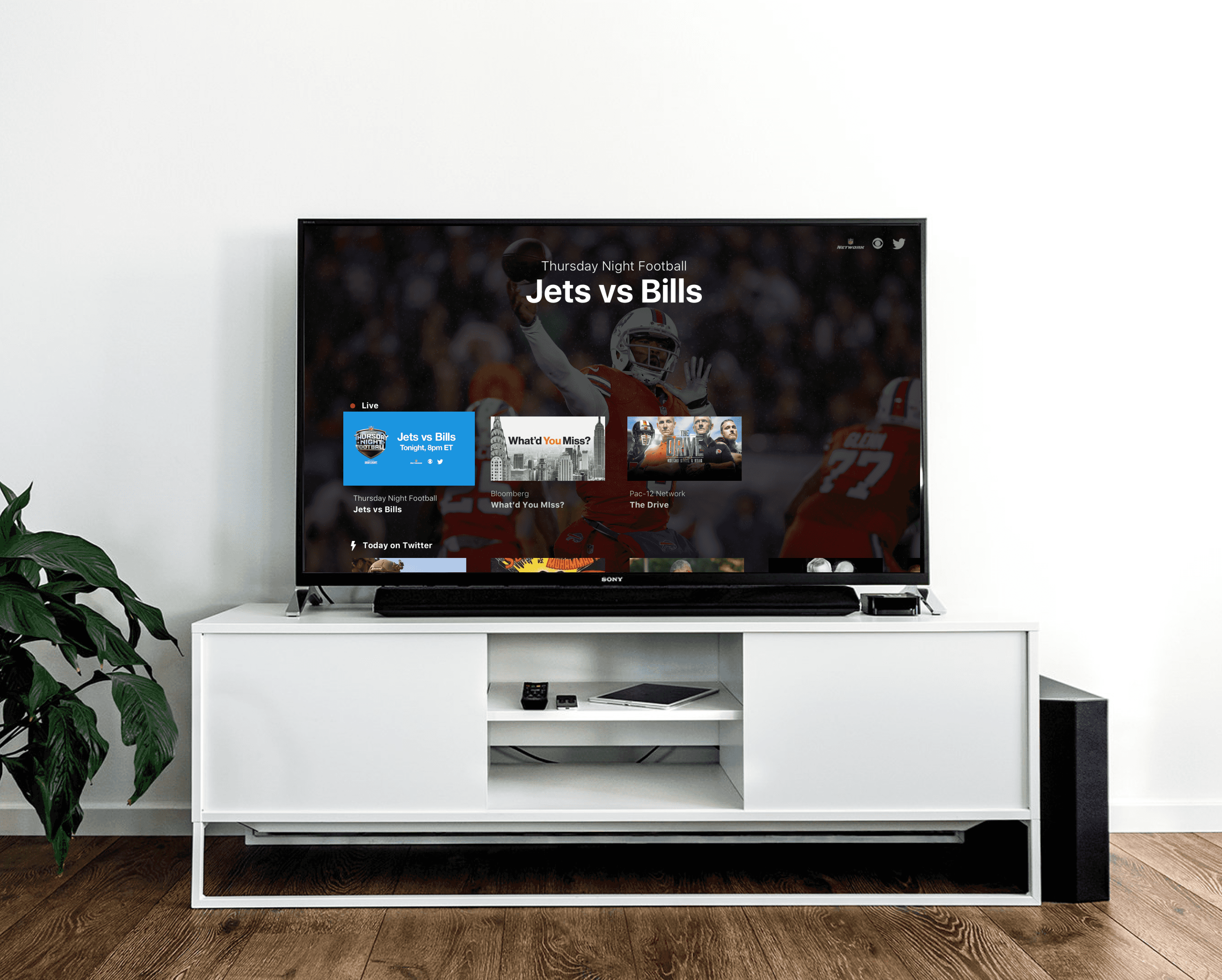 Large TV on TV stand showing the Twitter (X) TV app