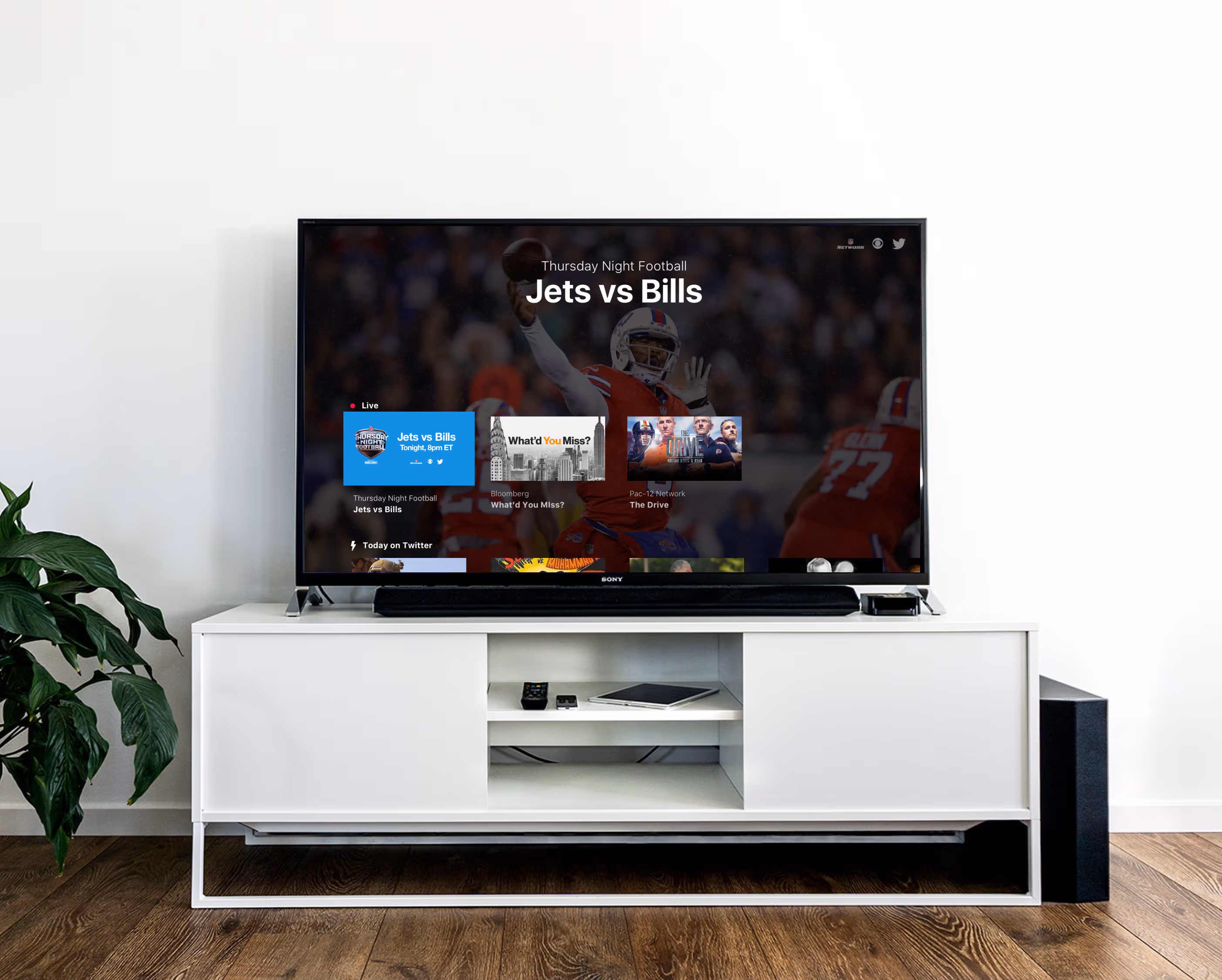 Large TV on TV stand showing the Twitter (X) TV app